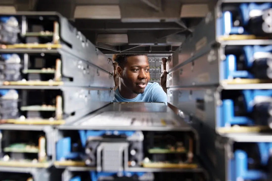 Ud Joseph surrounded by computer equipment.